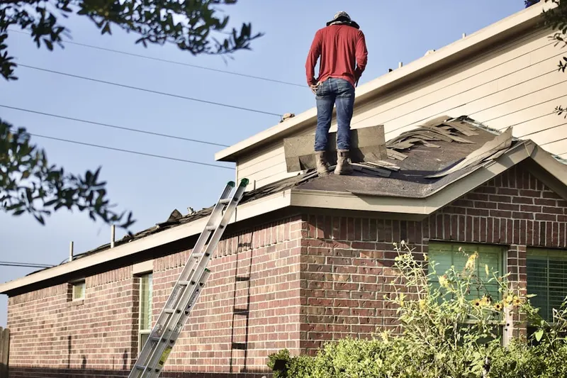 Professional roofer working on a residential roof in Wineland Vineyards